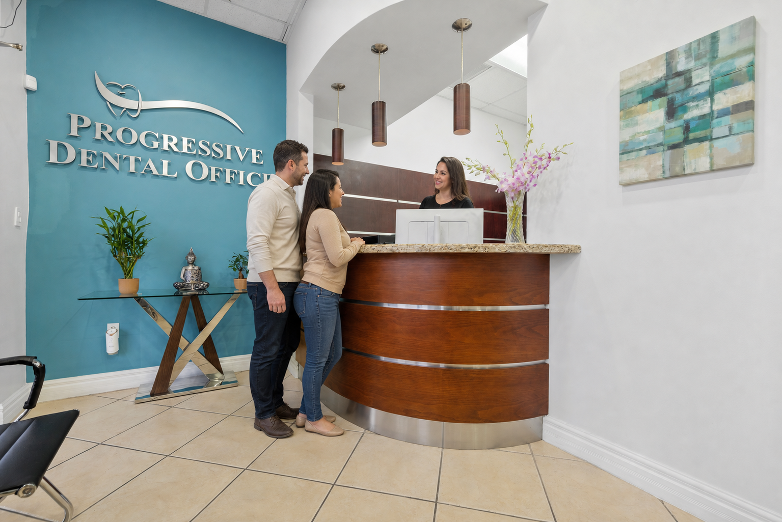 Patients checking in with a receptionist at Progressive Dental Office